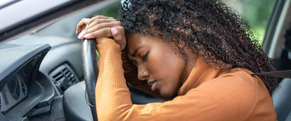 Frustrated black woman stuck in traffic jam